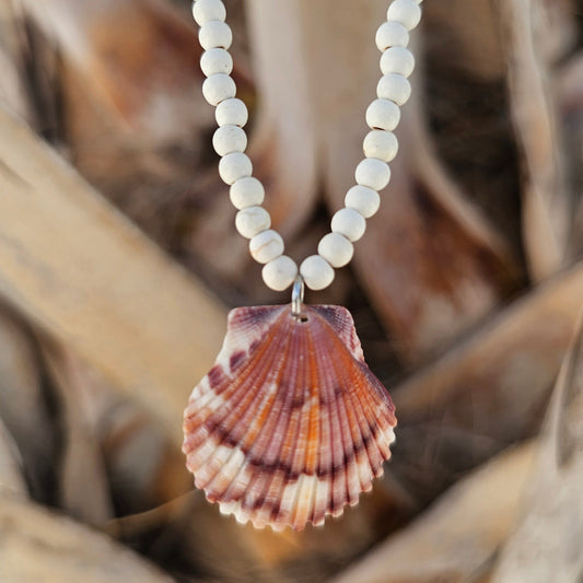 purple and orange scallop shell pendant on a white magnesite beaded necklace 